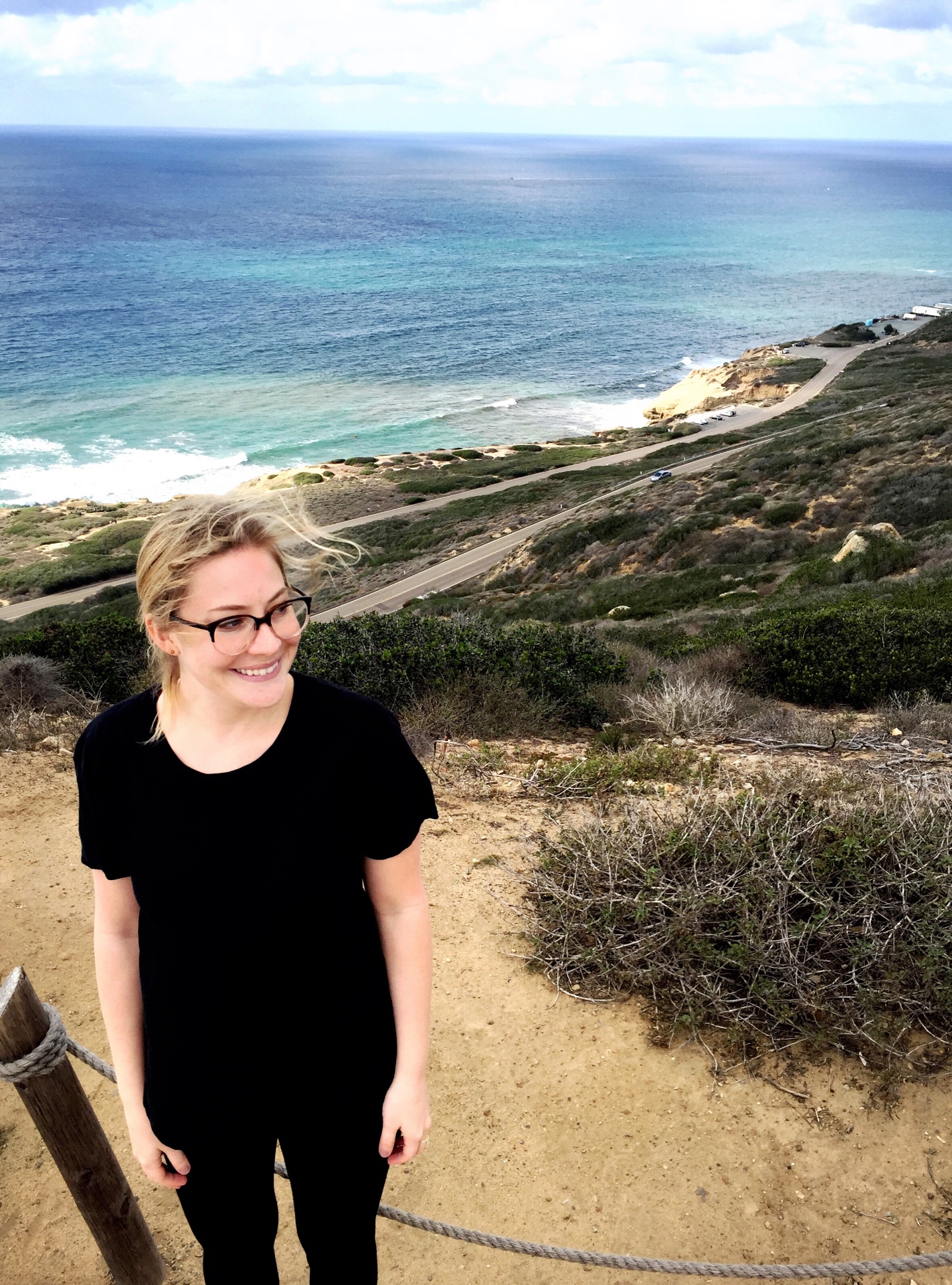Brittany Rice in 2015, smiling on a coastal hillside