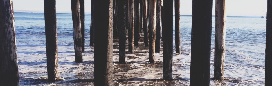 Under a wooden pier looking out to the ocean
